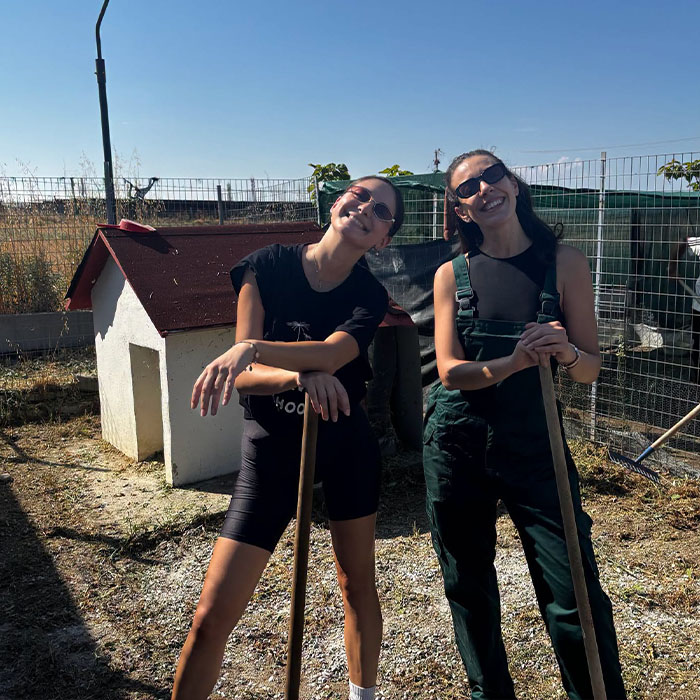 Teachers with gardening tools in the school garden