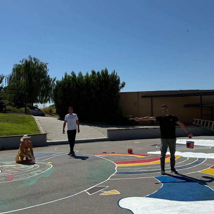Painting the schoolyard at Big Bang School